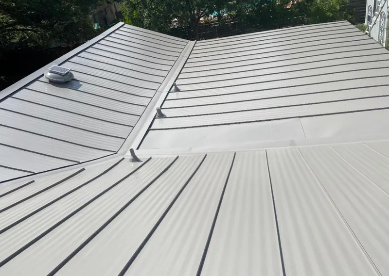 Solar attic fan installed on a metal roof for Roof Ventilation in Muskegon